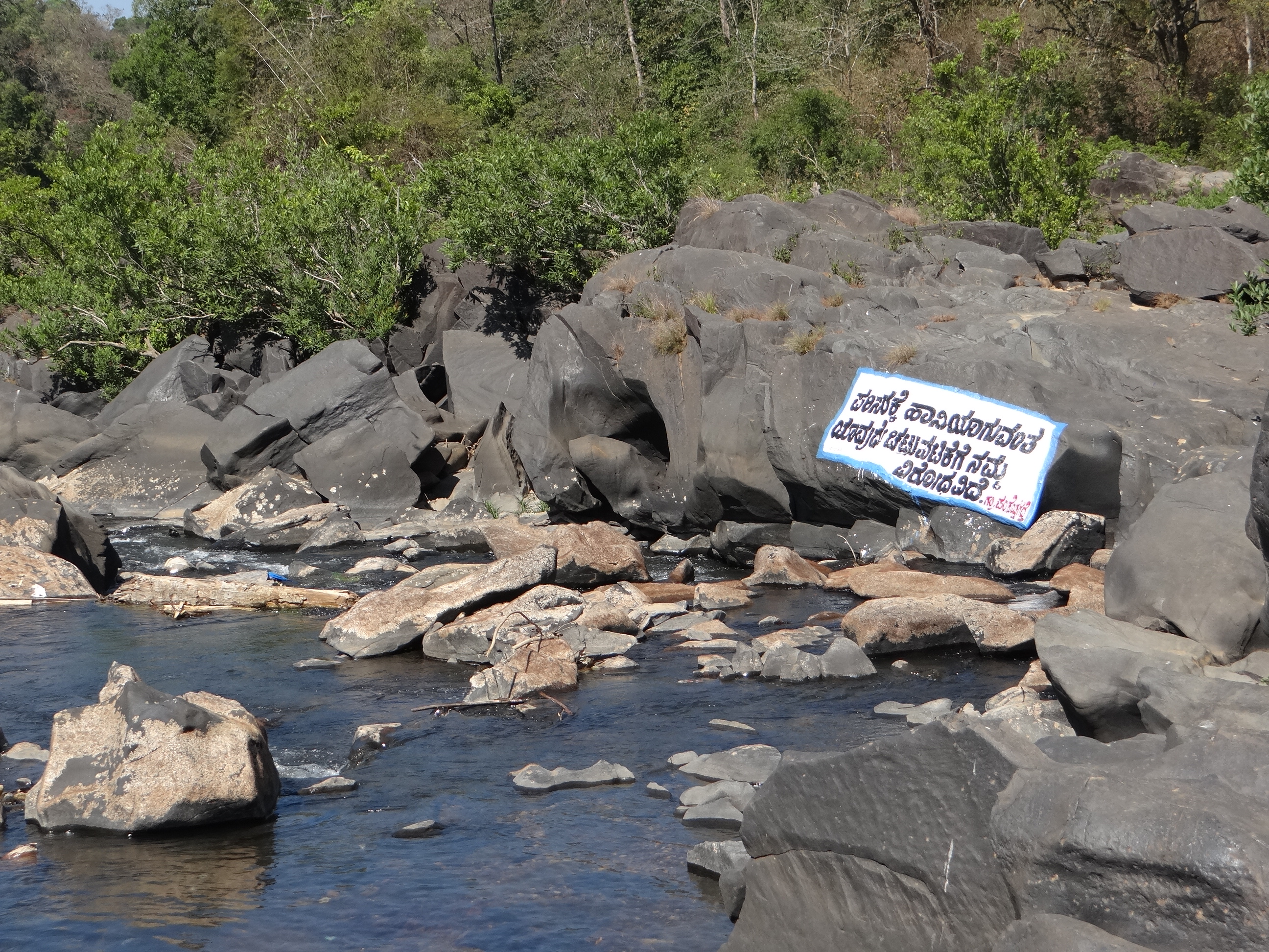 Sign on a river boulder