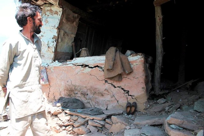 People of Dhalanjan village show their destroyed and dilapidated structures