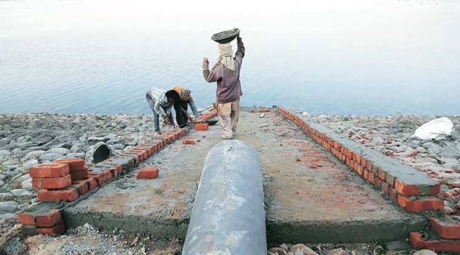 Pipe being laid to artificially fill Sukhna Lake in Chandigarh on January 12. (Express Photo by Jaipal Singh)